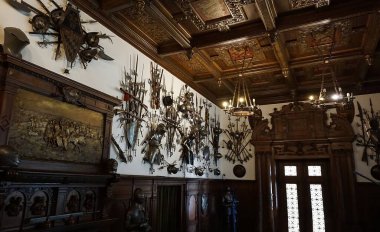 Sinaia, Romania - December 31, 2022: The interior of the Peles castle in Sinaia, in Romania - knightly armor and weapons.