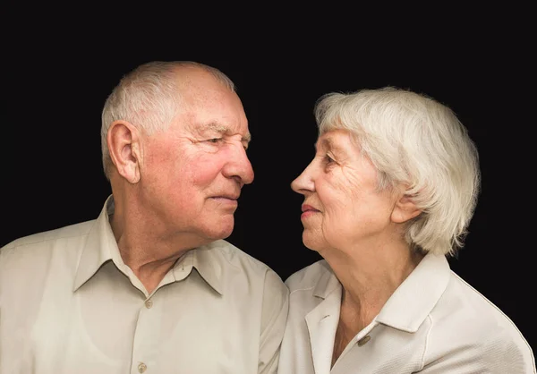 The elderly couple on a the black background