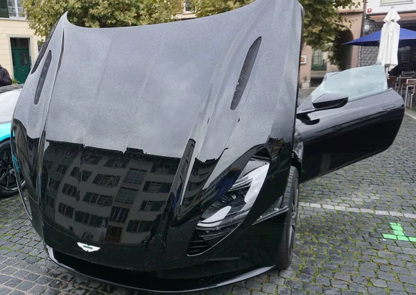 stock image Winterthur, Switzerland - October 21, 2023: Aston Martin in the dark. British supercar at Winterthur, Switzerland