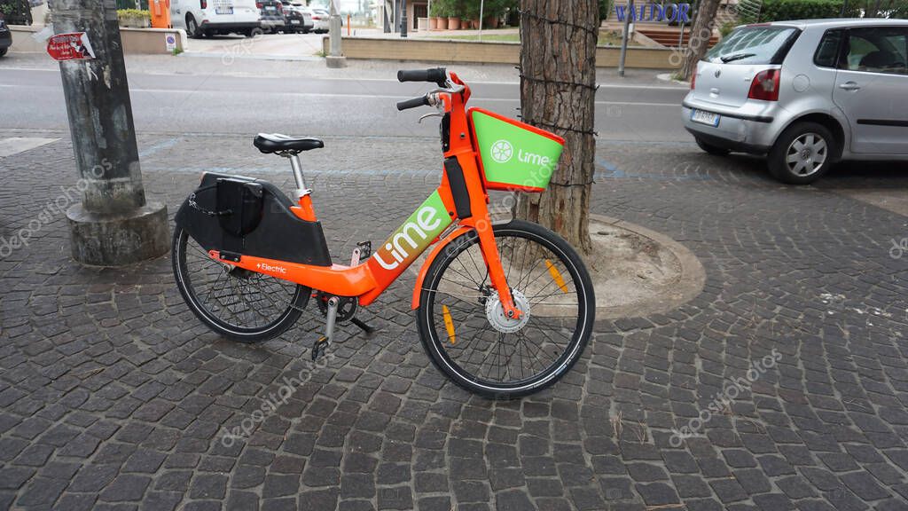 Rimini, Italy - June 25, 2024: Lime app sign brand and logo text on bicycle rent bike e-Scooter rental electric scooter company service of shared bikes