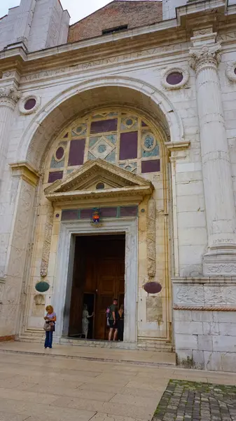 stock image Rimini, Italy - June 25, 2024: The people going near Tempio Malatestiano or IItalian Malatesta Temple is the cathedral church of Rimini, Italy.