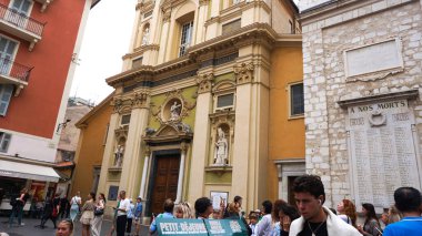 Nice, France - September 22, 2024: People going near Cathedrale Sainte-Reparate in Nice is a stunning Baroque masterpiece, known for its vibrant Facade and majestic dome, standing proudly in the heart of the Old Town since the 17th century clipart