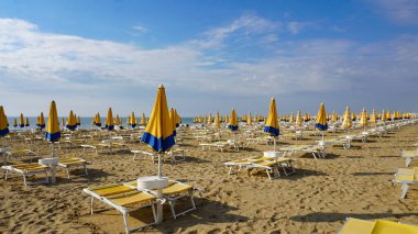 Venedik, Veneto bölgesi yakınlarındaki Lido di Jesolo plajında güneşli bir günde İtalya 'da şemsiyeler.