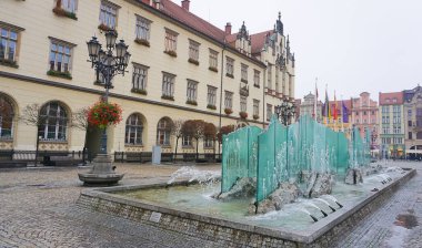 Wroclaw, Poland - April 17, 2022: The old town hall building with a clock in the center of Wroclaw Square at Poland clipart