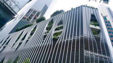 Singapore - January 20, 2025: CapitaSpring skyscraper with unique balcony with trees and plants, Designed by architectural firm BIG and Carlo Ratti Associati - biophilic skyscraper clipart