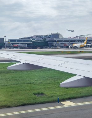 Singapore - January 20, 2025: Singapore airlines plane reaching Changi airport international terminal. View from aircraft clipart