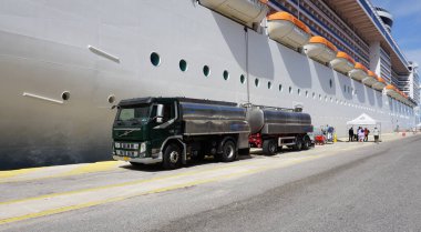 Korfu, Yunanistan - 9 Mayıs 2025: 9 Mayıs 2025 'te Yunanistan' ın Corfu limanına yanaşan bir yolcu gemisine yakıt ikmali yapan bir Volvo kamyonu
