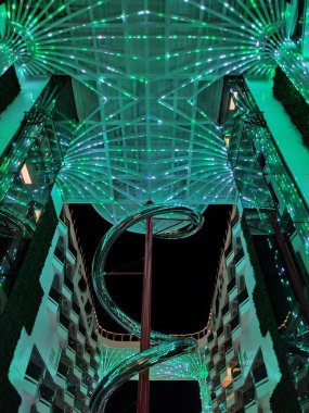 Valletta, Malta - September 24, 2025: Beautiful view of illuminated deck and promenade from MSC World Europa cruise ship. Dry stainless steel spiral slide called Venom Drop The Spiral