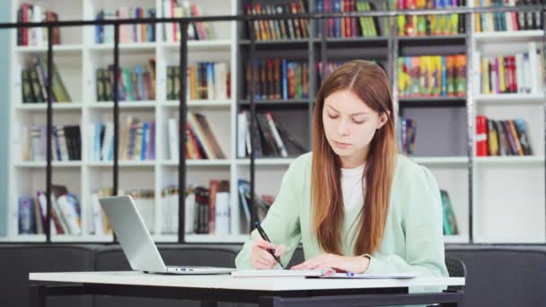 Caucasian Female Student Studying Library Stops Writing Looking Out Window — Stock Video