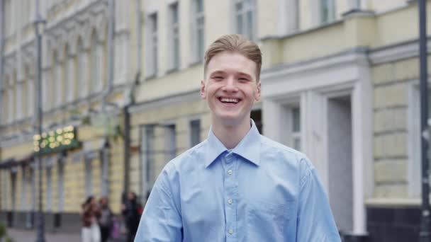 Young Smiling Blond Man Looking Camera Doing Sign Thumbs Blurred — Stock Video
