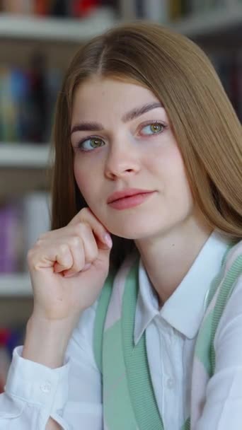 Vertical Screen Young Woman Long Hair Daydreaming Bookcases Blurred Background — Wideo stockowe