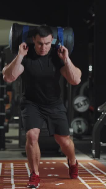 Layar Vertikal Bodybuilder Dalam Pakaian Olahraga Hitam Melakukan Latihan Serangan — Stok Video