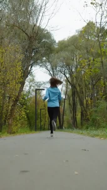 Vertical Screen Slow Motion Female Runner Wearing Blue Jacket Black — Stock Video
