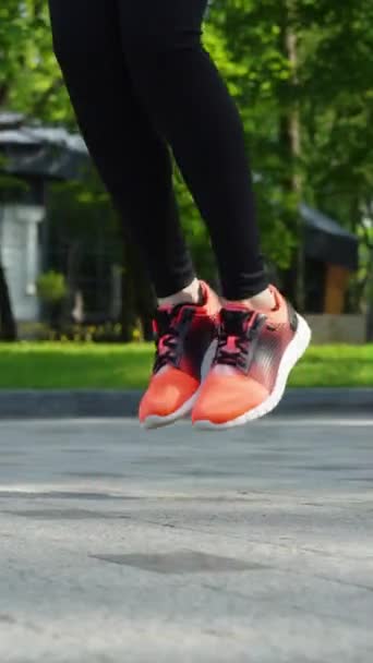 Vertical Screen Female Feet Jumping Skipping Rope Paved Ground Arc — Stock Video