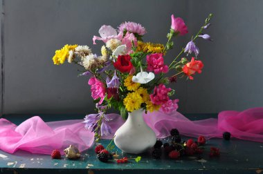 bouquet of flowers in a vase on a dark background