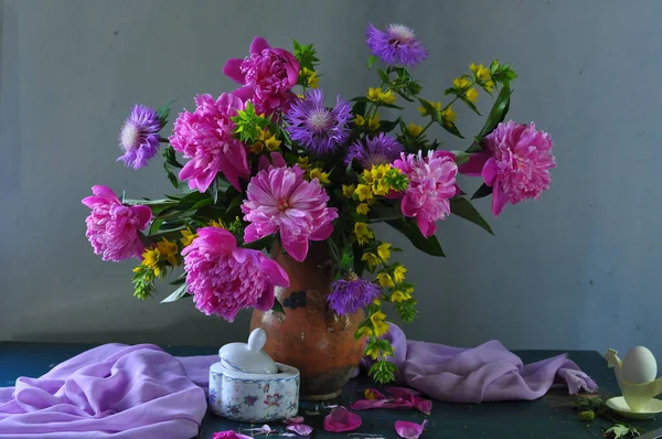 stock image still life with colorful flowers and a glass of water