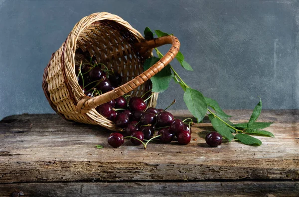 stock image basket with red plums and fresh cherry 