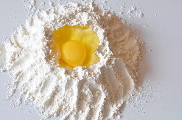 stock image flour and egg shells on white table 