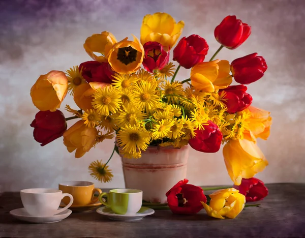 yellow, red, white and yellow tulips and yellow tulips in vase.