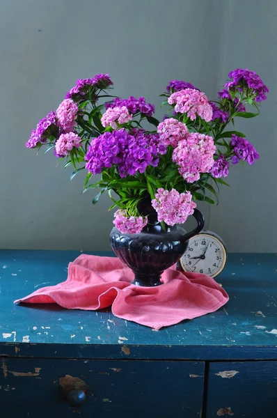 beautiful bouquet of lilac in vase on wooden table