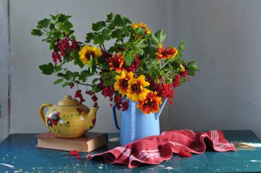 still life with a bouquet of flowers and a vase of sunflowers.  clipart