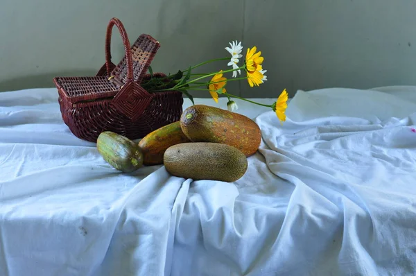 still life with flowers, fruit and a cup of tea.