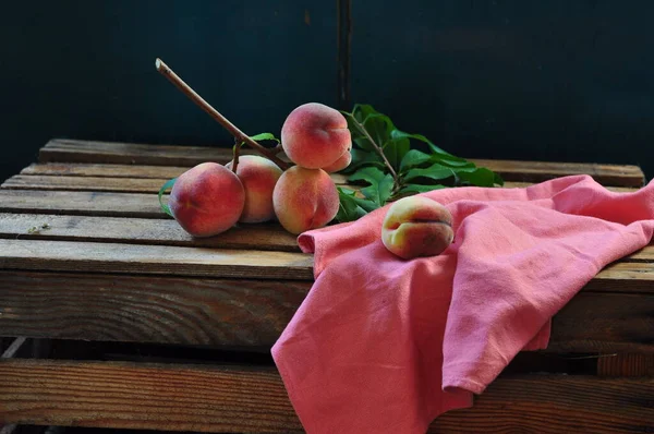 Reife Pfirsiche Mit Einem Korb Auf Einem Holztisch — Stockfoto
