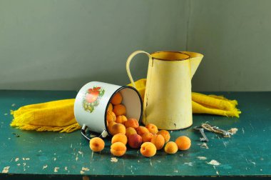 Bir fincan çay, bir buket kayısı ve bir vazo.