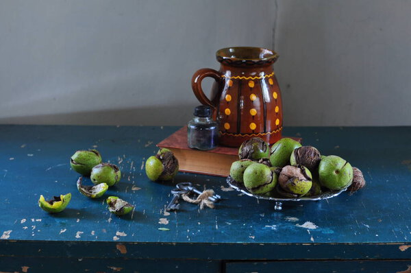 still life, apples and a jug of tea.
