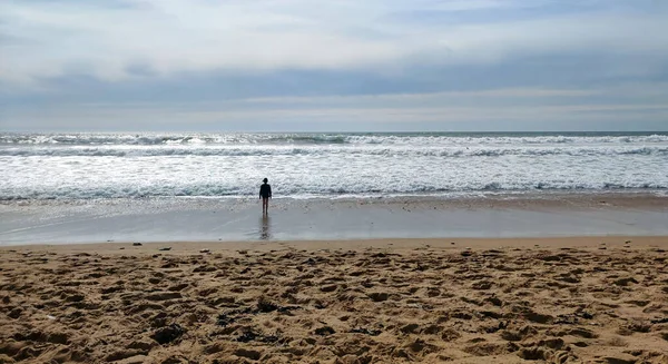 stock image Standing on the beach in front of the ocean