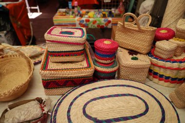Mexican straw boxes and baskets at market stall