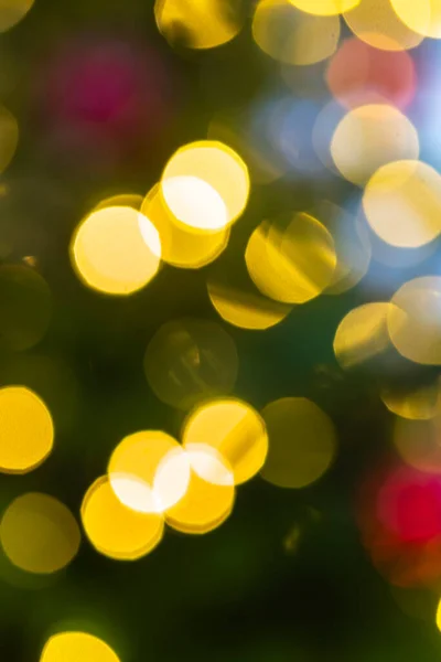 Blurred points of light on a Christmas tree. Background image: Lights glow in the dark