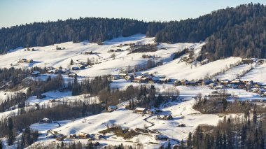 alpine village, Austria in winter, snowy scattered settlement in the valley, with mountains around, in the valley is a collection of farmhouses between meadows and forests, beautiful winter landscape clipart