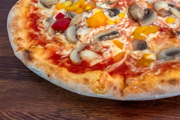Funghi pizza: A mouthwatering pizza topped with tomato sauce, melted cheese, flavorful mushrooms, vibrant peppers, and sweet corn, all served on a rustic wooden table. A perfect combination of flavors for a satisfying and wholesome dining experience.