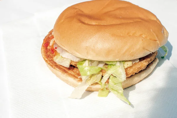 Chicken Burger: A juicy chicken burger with vibrant lettuce and zesty tomato ketchup, creating a delightful and flavorful experience with each bite.