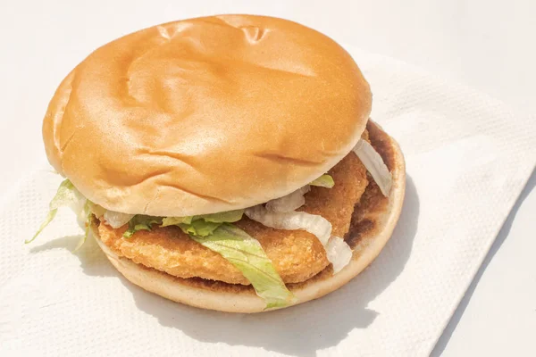 Chicken Burger: A juicy chicken burger with vibrant lettuce and zesty tomato ketchup, creating a delightful and flavorful experience with each bite.