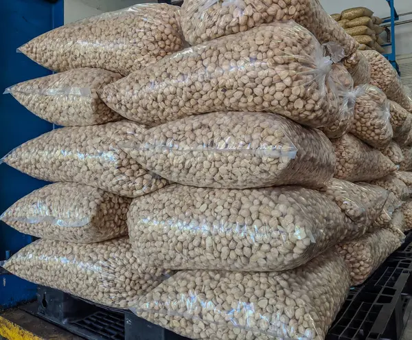 stock image stock of candlenuts wrapped in transparent plastic in the factory warehouse for instant seasoning raw materials. food factory