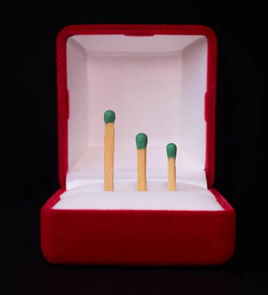 three matches in a red gift box