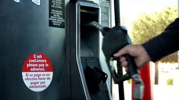 ガソリンスタンドでガソリンポンプノズルを選択する男 — ストック動画