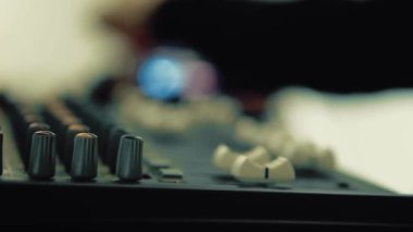 Profesyonel ses karıştırıcı konsolunu düğmeler ve ev yapımı müzik masasıyla ayarlıyorum.