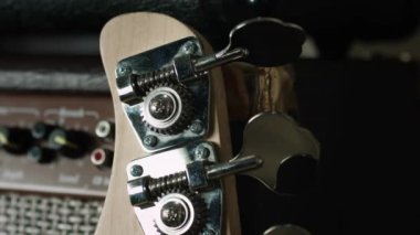 Yakın plan insan parmak ayarlı gitar. Mandallar perls bas akortçular ensesi müzik çalmak için izole