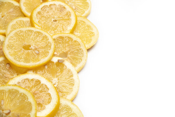 overlapping lemon slices on white background with copy space