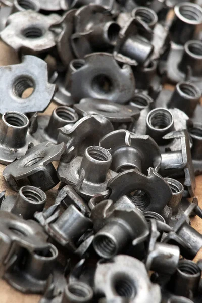 stock image T nut, tee nut, blind nut, flush fitting, pronged nut, used to mount materials to a work piece leaving a flush surface, woodworking, joint