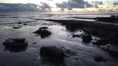 San Diego yakınlarındaki Güney Kaliforniya plaj sahneleri - Encinitas California 'daki Swamis Resif Sörf Parkı' ndaki günbatımları, sörfçüler, gelgit havuzları, dalgalar, kayalar, kum plajları ve palmiye ağaçları.