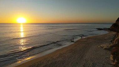 San Diego 'nun kuzeyindeki Güney Kaliforniya plaj sahneleri - Encinitas California' daki Swamis Resif Sörf Parkı 'ndaki altın günbatımları, sörfçüler, gelgit havuzları, dalgalar, kayalar, kumlu plajlar ve palmiye ağaçları.