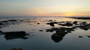 Güney Kaliforniya plaj sahneleri gelgit havuzları, soyut kaya oluşumları, okyanus dalgaları sörf tahtaları, gün batımı siluetleri ve Swamis Resif Parkı Encinitas California 'da sıcak şeftali rengi gökyüzü..