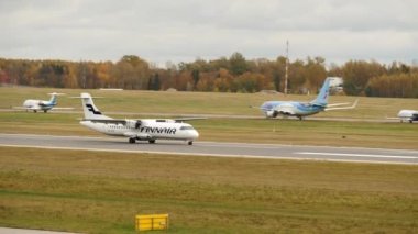 Vilnius, Lithuania - November 03, 2022: The small white Finnair aircraft on the airport runway after landing at Vilnius Airport.