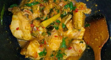 Ayam woku is a traditional dish from the Minahasa or Manado region of Indonesia, made of a chicken cooked mix of herbs and spices, ingredients are lemongrass, turmeric, kaffir lime leaves, and chili pepper home made cooking clipart
