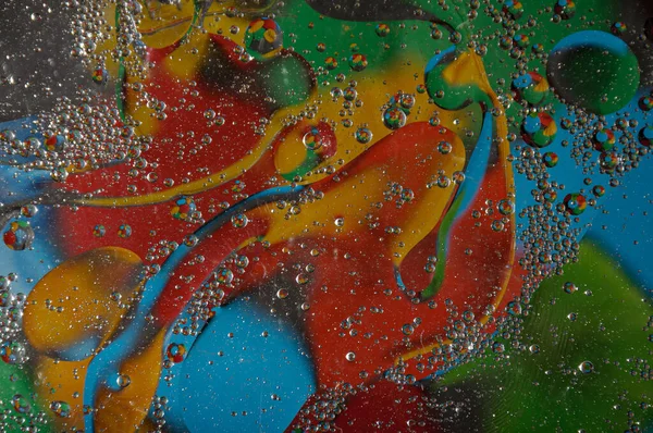 Soyut fotoğrafçılık. Renkler kırmızı, mavi, sarı, yeşil, siyah, beyaz, gümüşümsü. Damlalar, yüzeydeki nesneler. Arkaplan, tasarım ve iç tasarım için fotoğraflar.