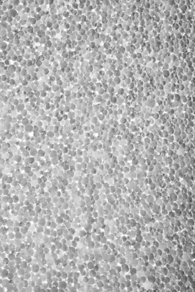 Arkaplan ve tasarım için yapay köpük dokusu. Köpüğün tek renkli görüntüsü. Fotoğraf konusunun arka ışıklandırması. makro fotoğrafçılık.